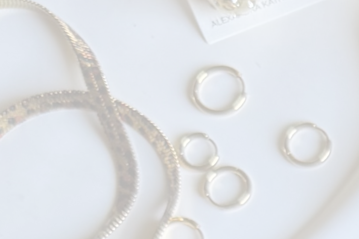 GOLD jewelry pieces on a white plate